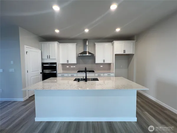 a stove top oven sitting inside of a kitchen