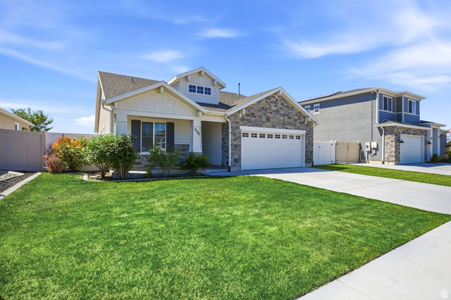 1175 Silver Hollow Road Syracuse, UT 84075 - Photo 4 of 34 Contemporary exterior featuring stone accents, horizontal siding, and gable rooflines
