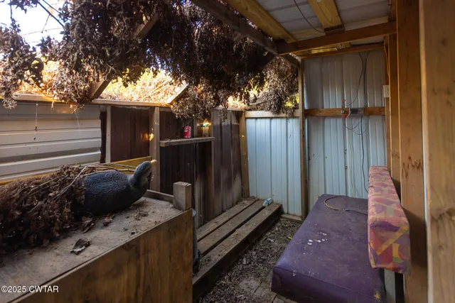 a view of a backyard with chairs and a fire pit