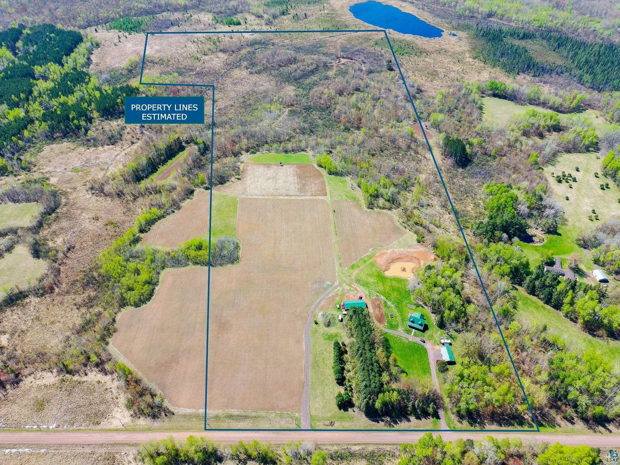 37590 Degerstrom Road Askov, MN 55704 - Photo 6 of 53 Expansive acreage featuring a mix of open fields, wooded areas, and a natural pond