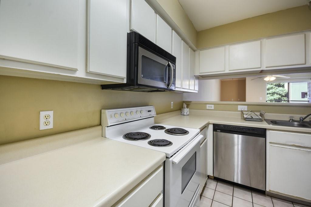 501 West 26th Street, Unit 104 Austin, TX 78705 - Photo 2 of 10 a kitchen with a sink a stove and cabinets