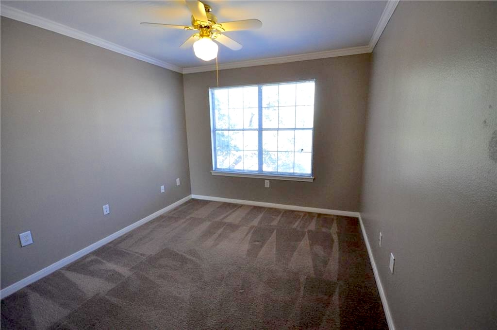 501 West 26th Street, Unit 104 Austin, TX 78705 - Photo 5 of 10 an empty room with a window and a fan