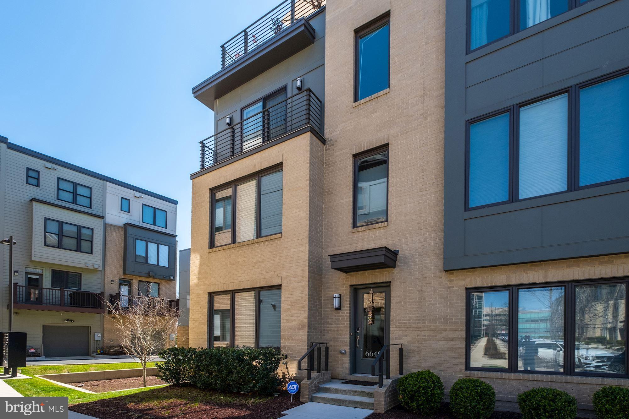 a front view of a residential apartment building with a yard