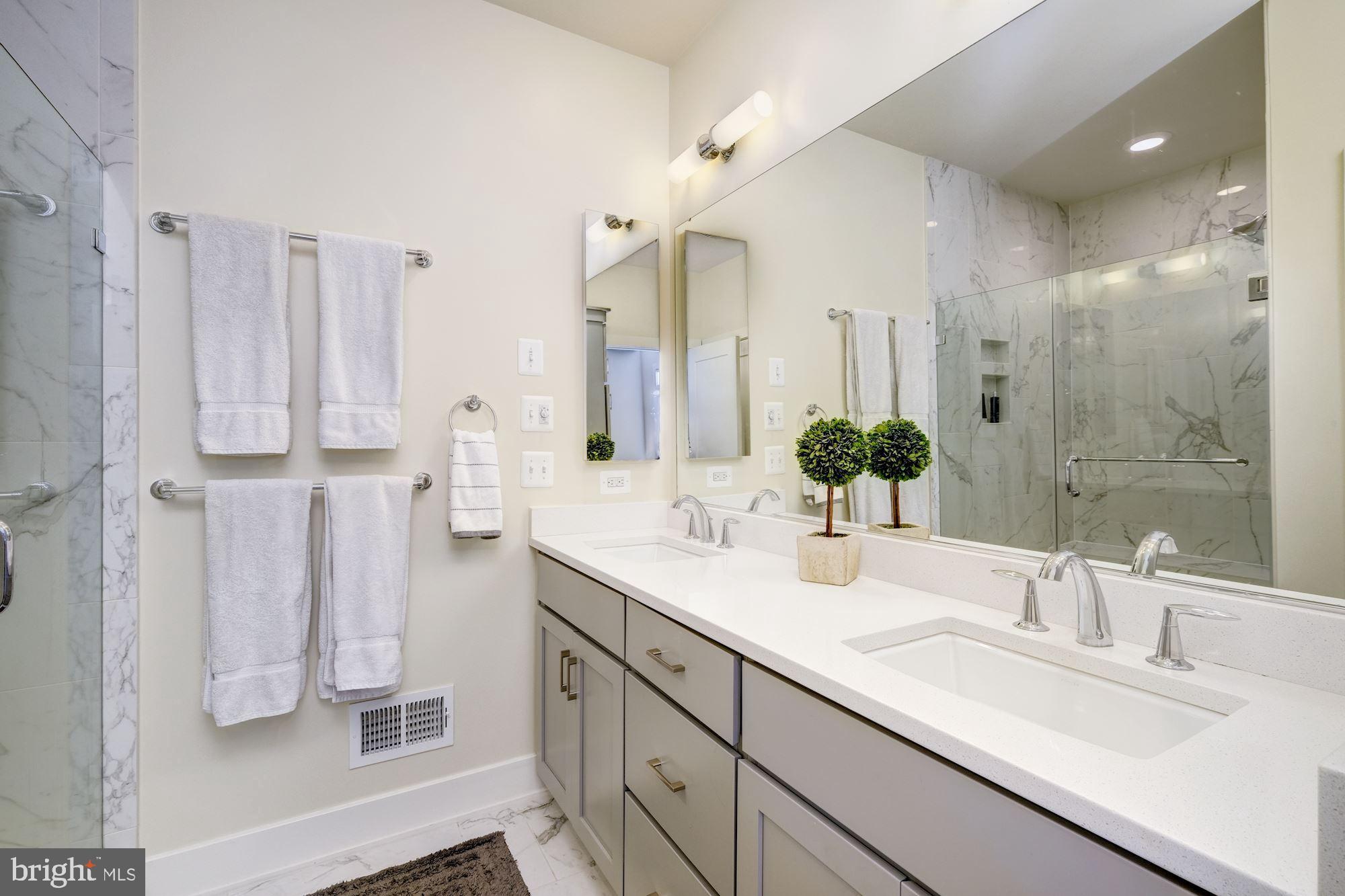 6640 Eames Way Bethesda, MD 20817 - Photo 21 of 38 a bathroom with double vanity and a mirror