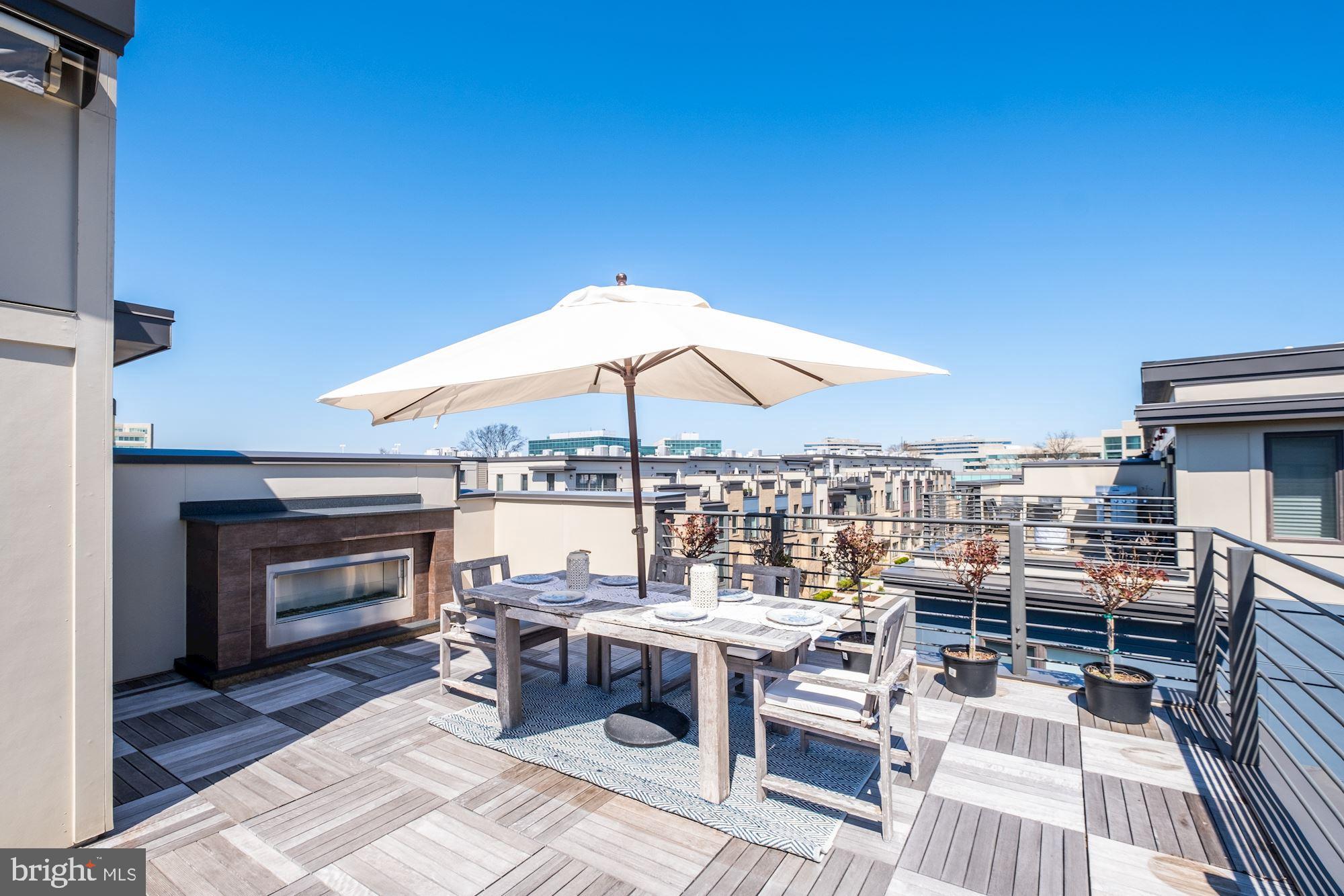 6640 Eames Way Bethesda, MD 20817 - Photo 28 of 38 an outdoor space with furniture and umbrella
