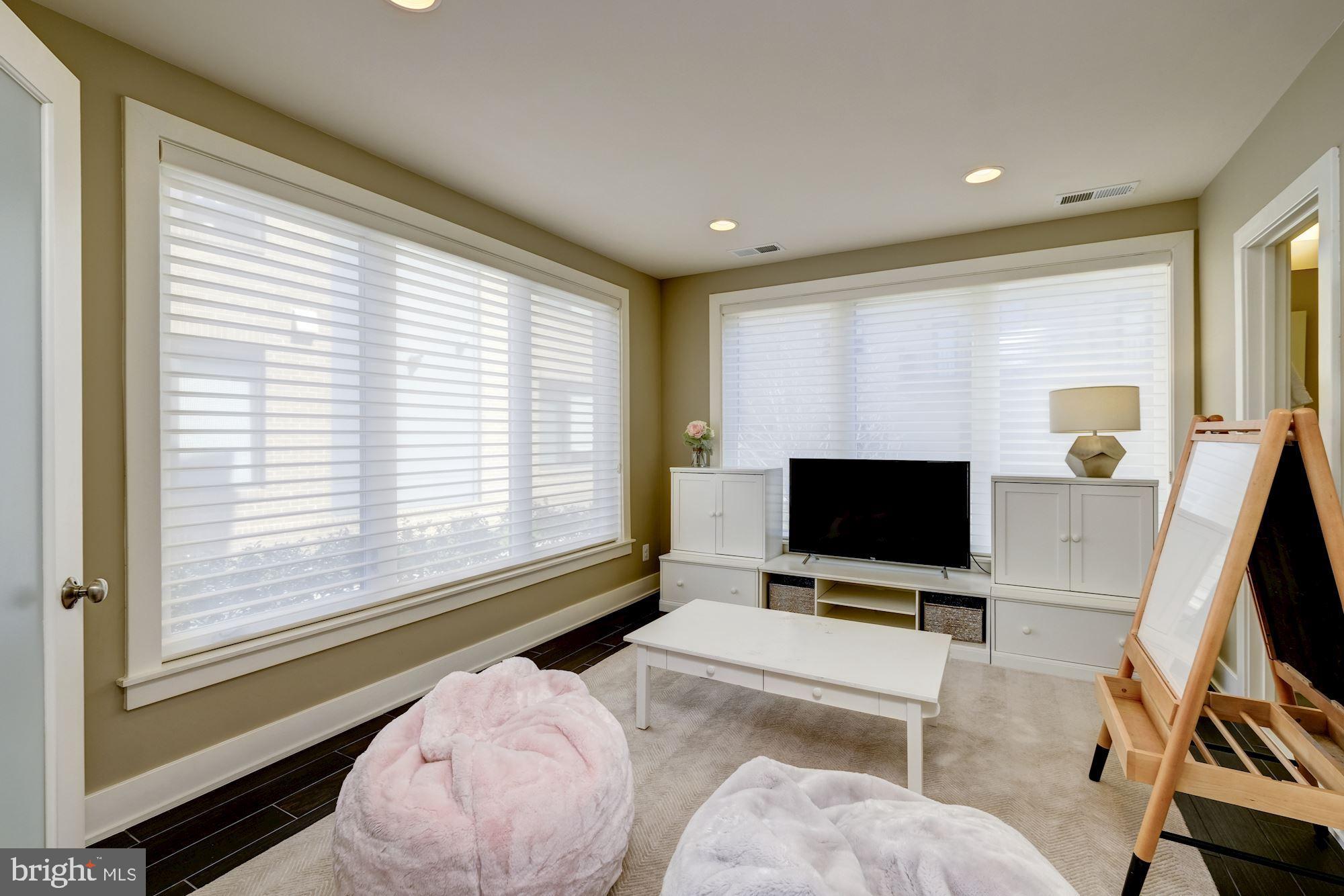 6640 Eames Way Bethesda, MD 20817 - Photo 29 of 38 a living room with furniture and a flat screen tv