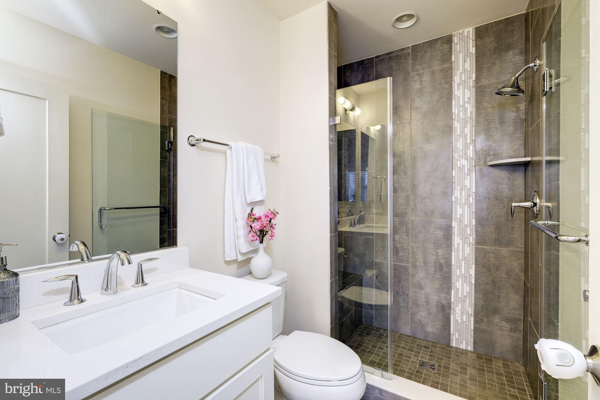 6640 Eames Way Bethesda, MD 20817 - Photo 31 of 38 a bathroom with a sink toilet vanity and shower