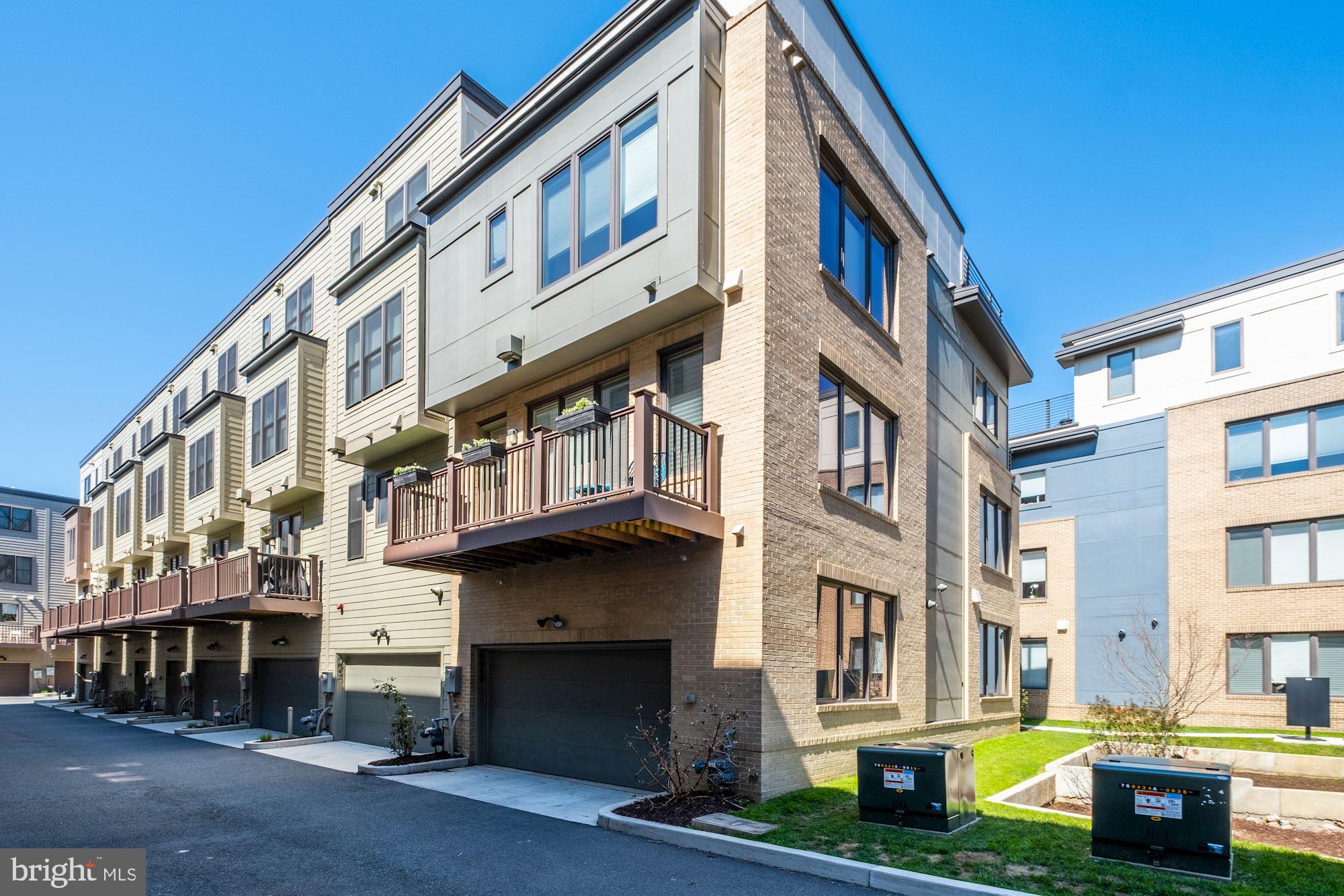 6640 Eames Way Bethesda, MD 20817 - Photo 33 of 38 a bricked building with multiple windows and a yard