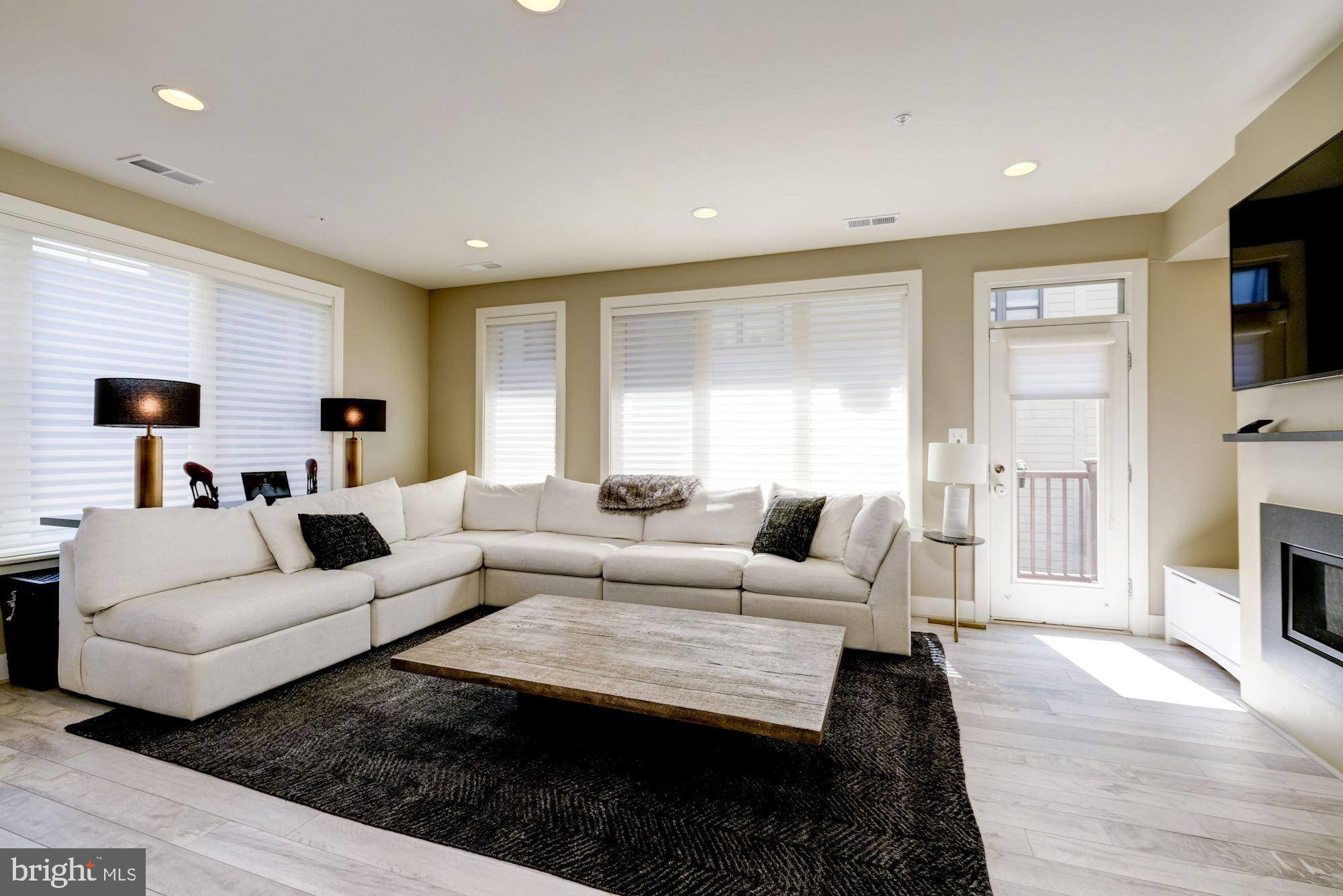 6640 Eames Way Bethesda, MD 20817 - Photo 10 of 38 a living room with fireplace furniture and a flat screen tv