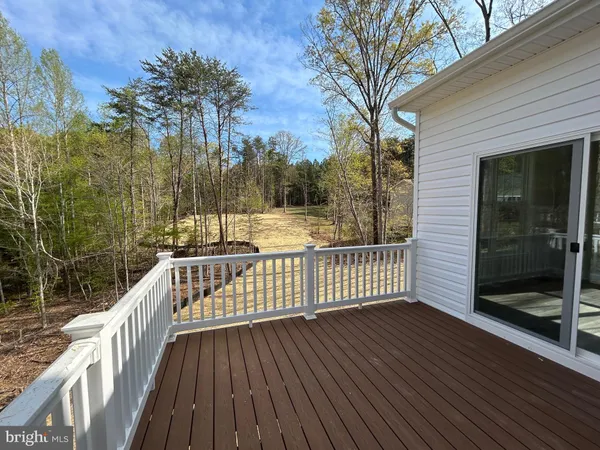 a view of balcony with wooden floor and fence