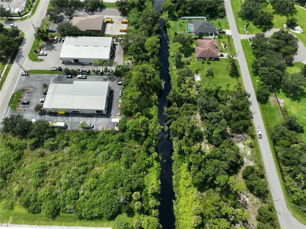 Oceanside St Port North Port, FL 34286 - Photo 7 of 10 an aerial view of residential house with outdoor space and trees all around