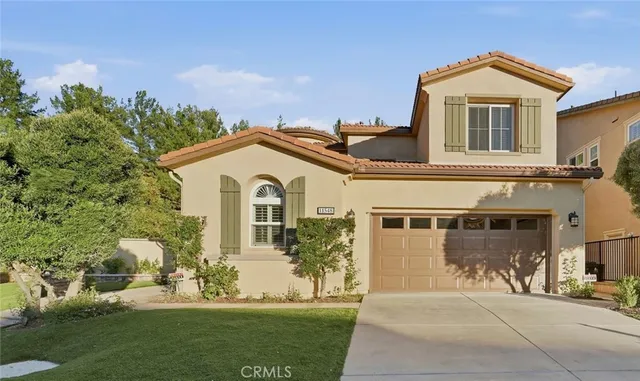 a front view of a house with a garden and yard