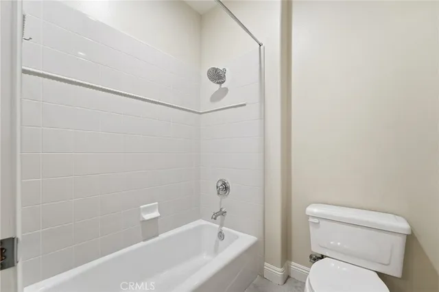 a bathroom with a toilet and a bathtub
