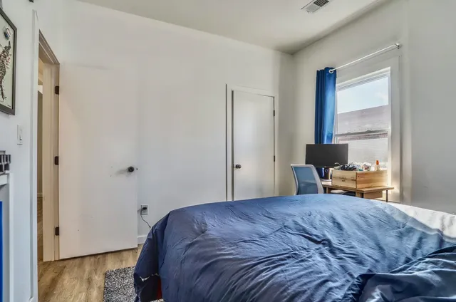 a bedroom with furniture and a window