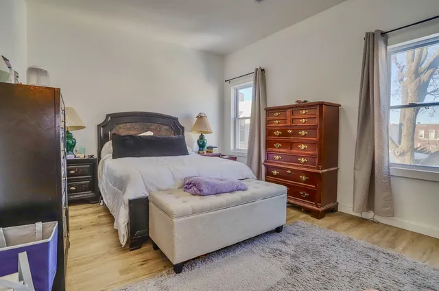 a bedroom with a bed and dresser