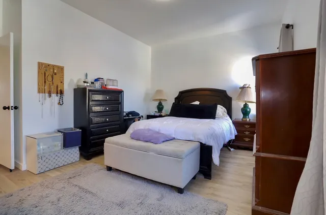 a bedroom with a bed and a television