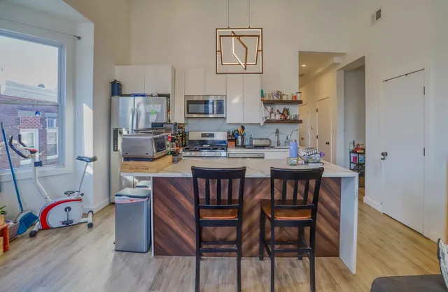 a dining room with furniture and wooden floor