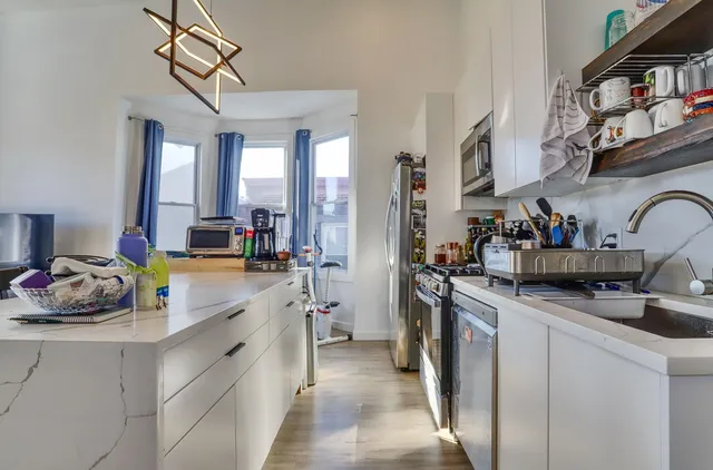 a kitchen with a sink cabinets and appliances