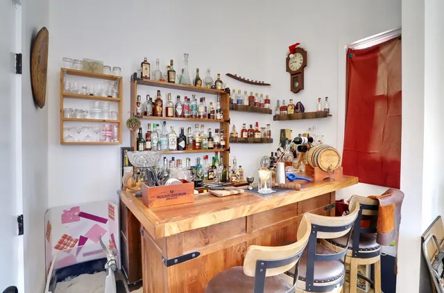 a room with stainless steel appliances a dining table and chairs in it