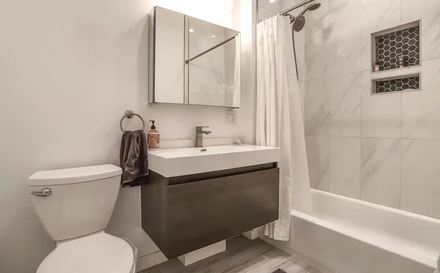 a bathroom with a sink toilet and shower