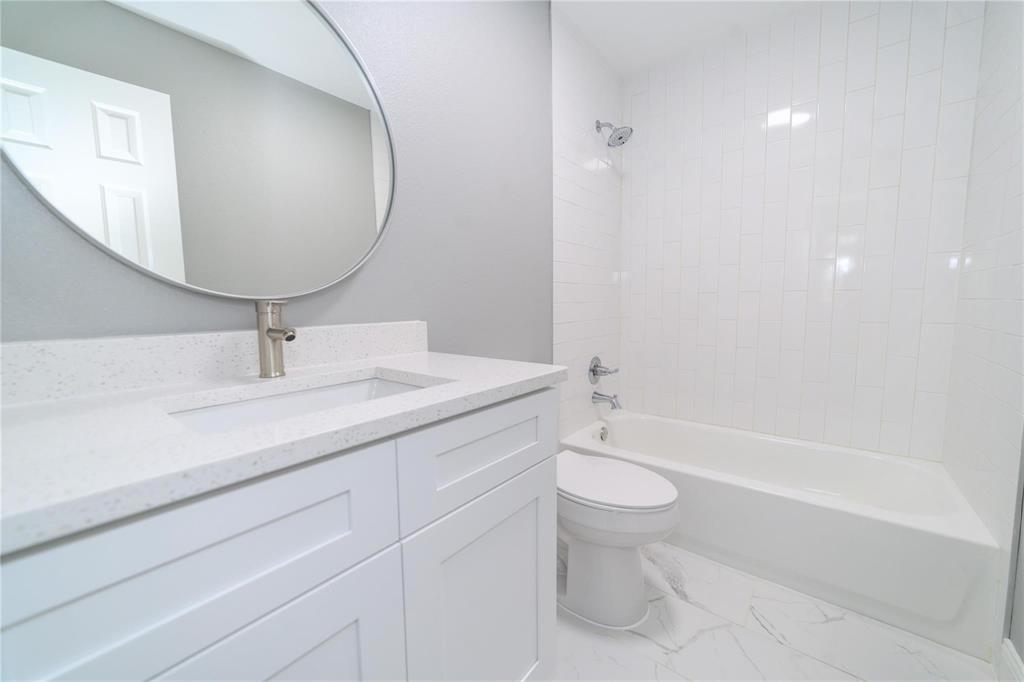 809 Wilcox Street McKinney, TX 75069 - Photo 21 of 26 Bathroom with vanity, shower / tub combination, and light marble finish flooring