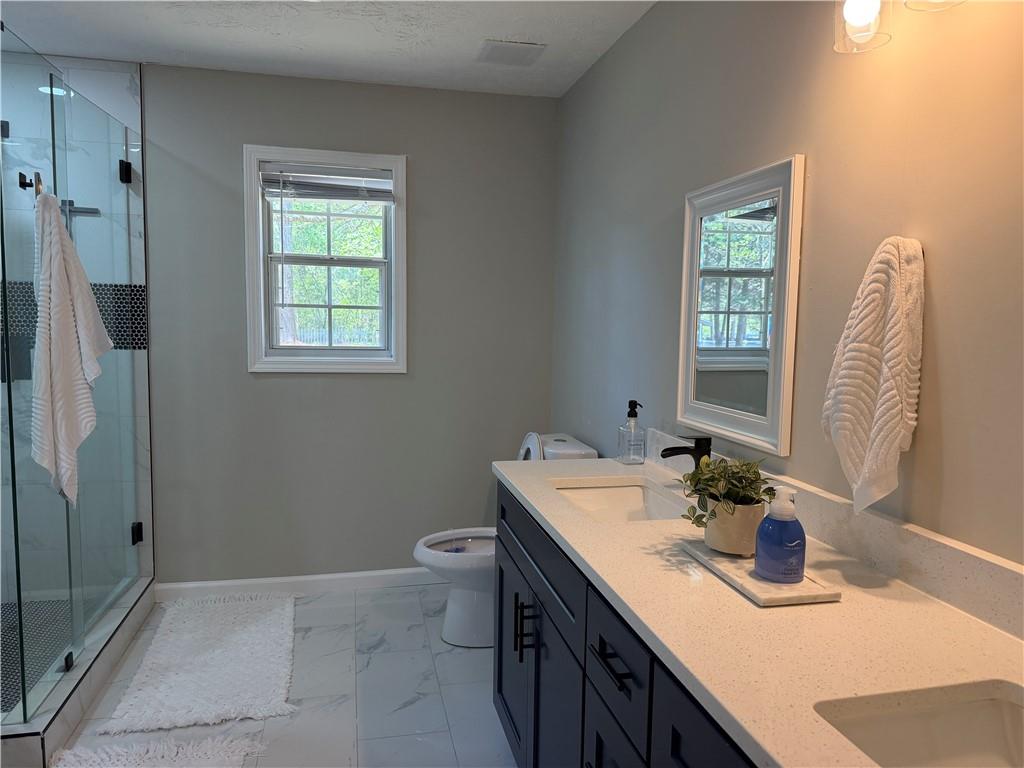 934 Bay Ridge Drive Lawrenceville, GA 30045 - Photo 56 of 78 a bathroom with a sink toilet and shower