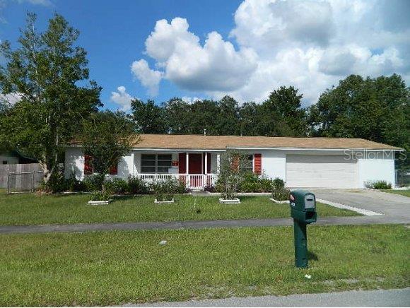 4113 Southwest 143rd Ln Road Ocala, FL 34473 - Photo 1 of 1 a front view of house with yard and green space