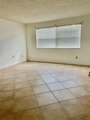 a view of an empty room with glass door