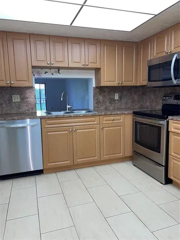 an empty room with wooden floor and a window