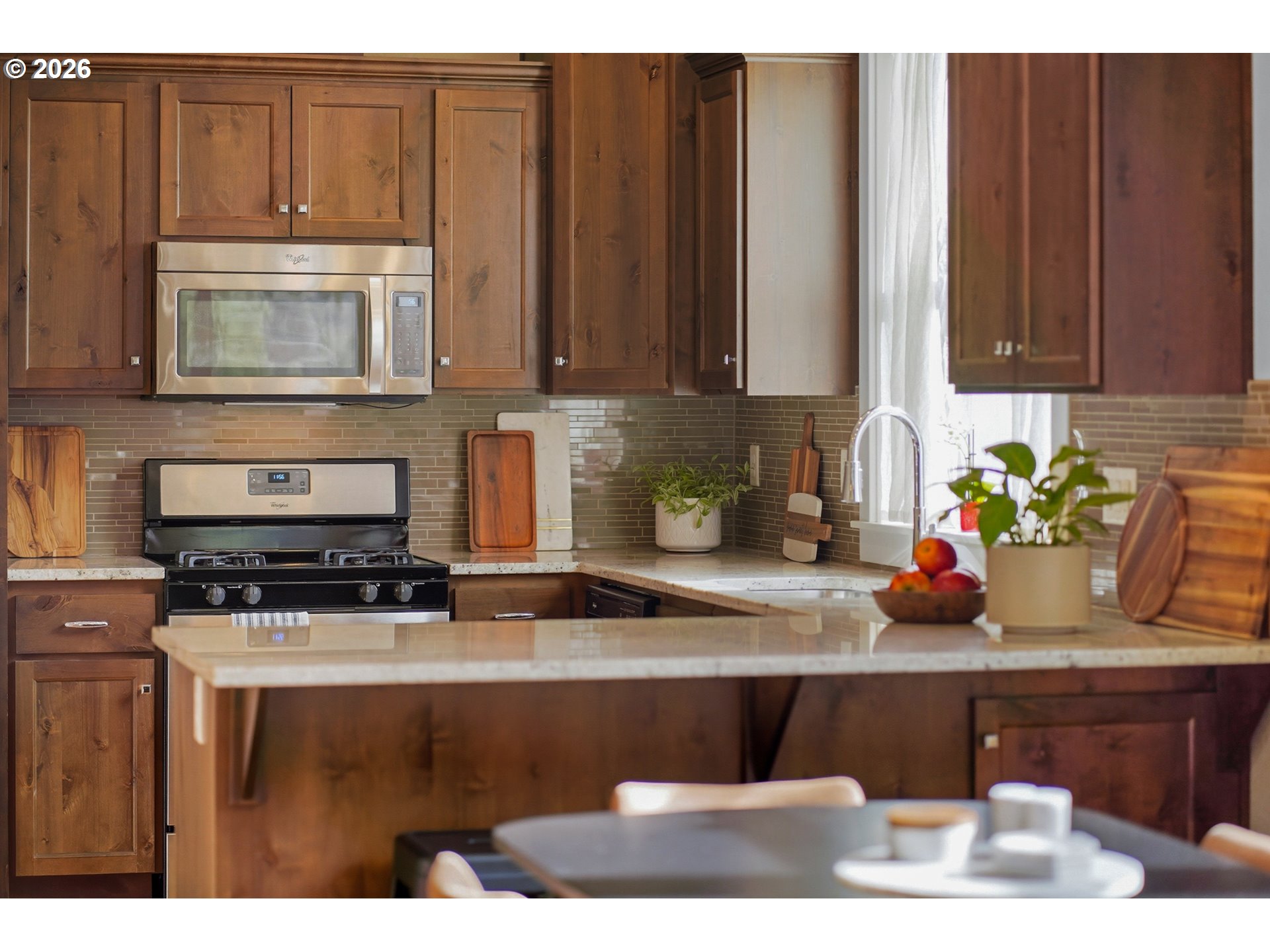 17390 Aubin Street Sandy, OR 97055 - Photo 17 of 41 a kitchen with granite countertop a stove a microwave a sink and cabinets
