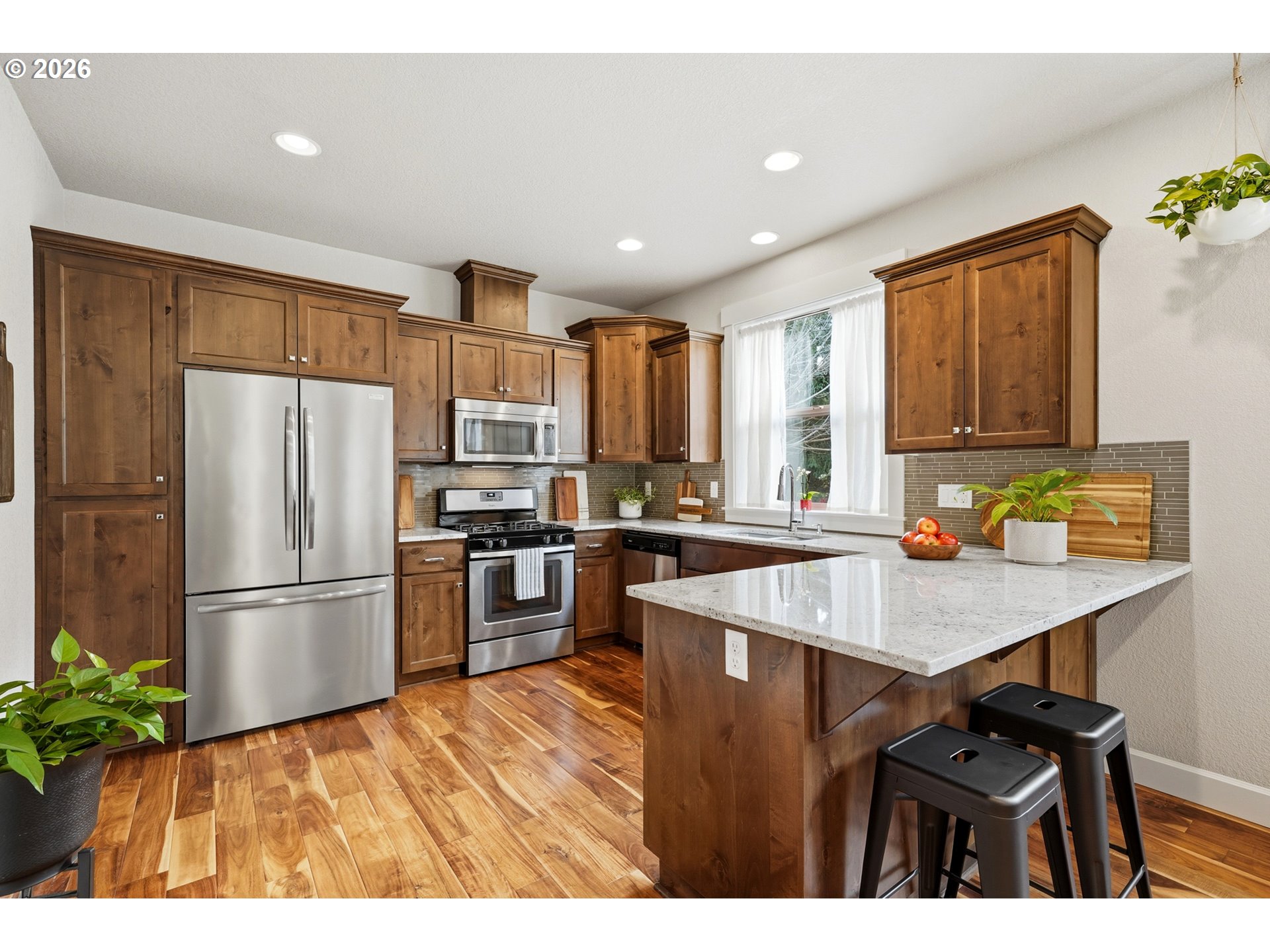 17390 Aubin Street Sandy, OR 97055 - Photo 18 of 41 a kitchen with a refrigerator a sink dishwasher with a dining table and chairs