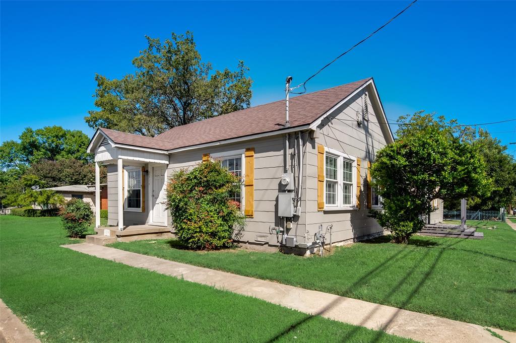 a front view of house with a garden