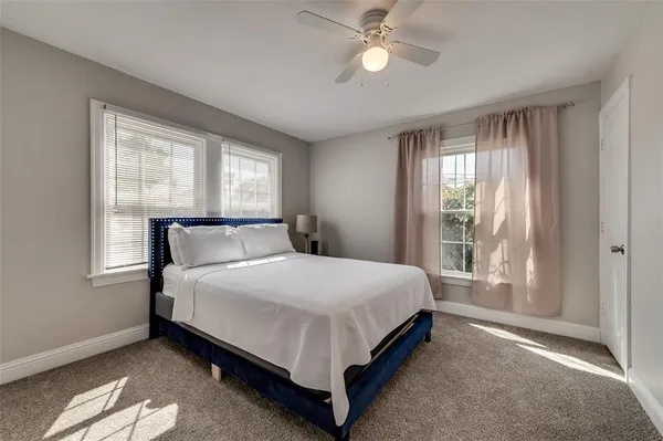 a large bed sitting in a bedroom next to a window