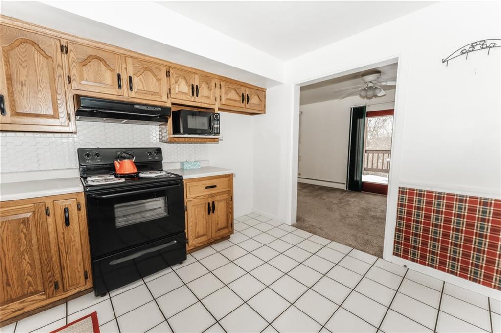 1061 Martin Road Tarentum, PA 15084 - Photo 3 of 25 a kitchen with stainless steel appliances granite countertop a stove and a microwave