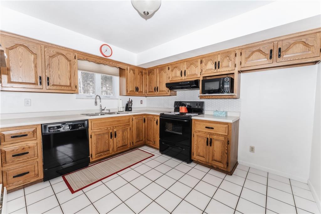 1061 Martin Road Tarentum, PA 15084 - Photo 4 of 25 a kitchen with stainless steel appliances granite countertop a sink and cabinets