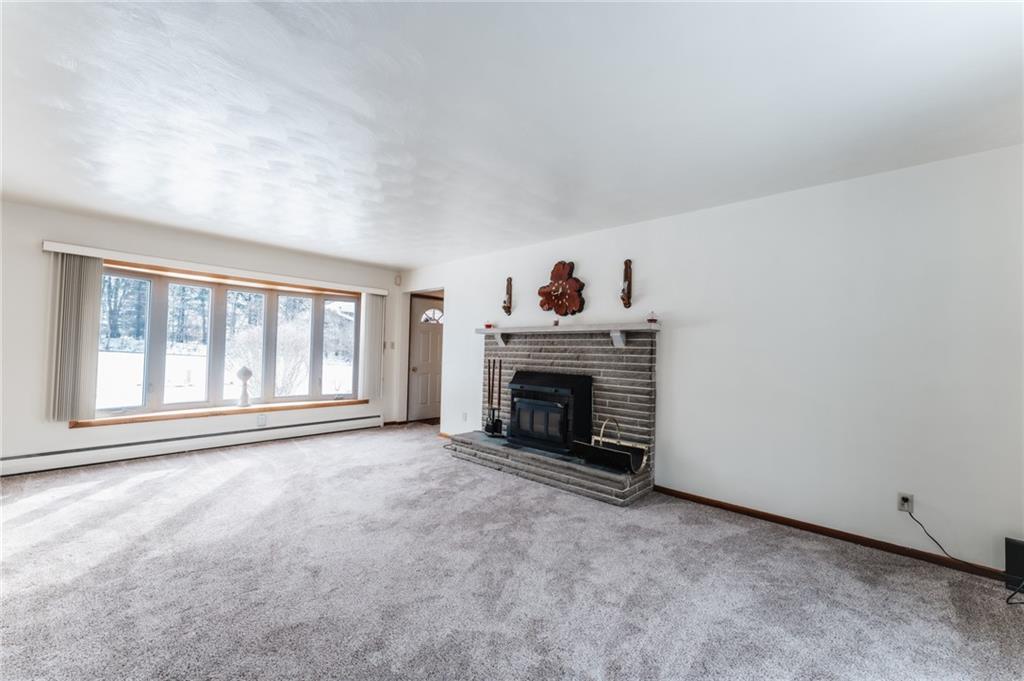 1061 Martin Road Tarentum, PA 15084 - Photo 5 of 25 a view of an empty room with a fireplace and a window