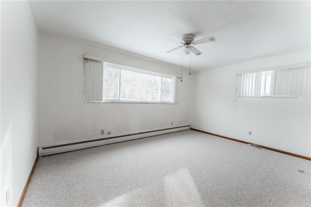1061 Martin Road Tarentum, PA 15084 - Photo 7 of 25 an empty room with windows and ceiling fan