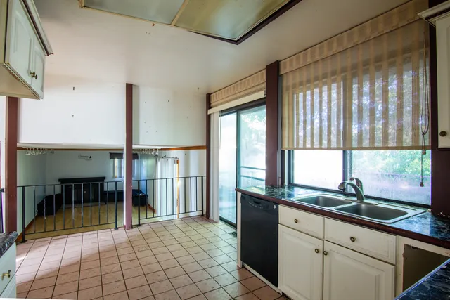 a view of a room with a sink and dining table