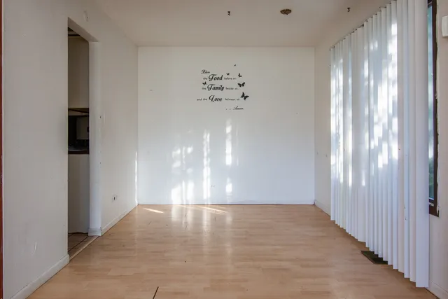 a view of a hallway with chandelier in a room