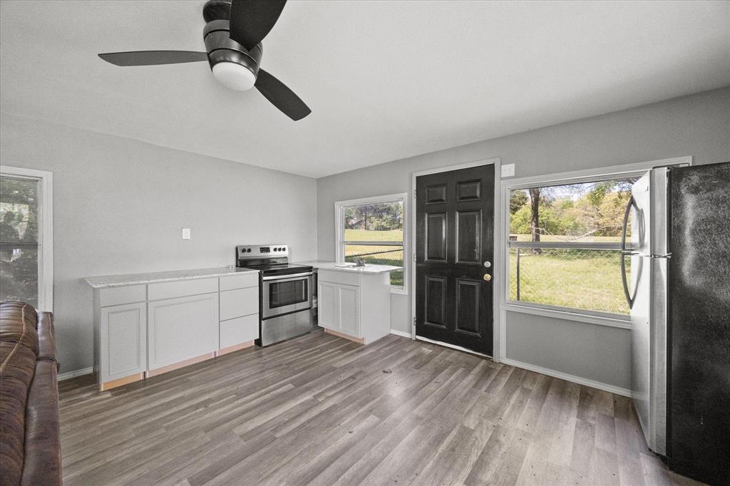 Tbd Waters Edge Quinlan, TX 75474 - Photo 25 of 32 a kitchen with stainless steel appliances a refrigerator a sink a stove and white cabinets