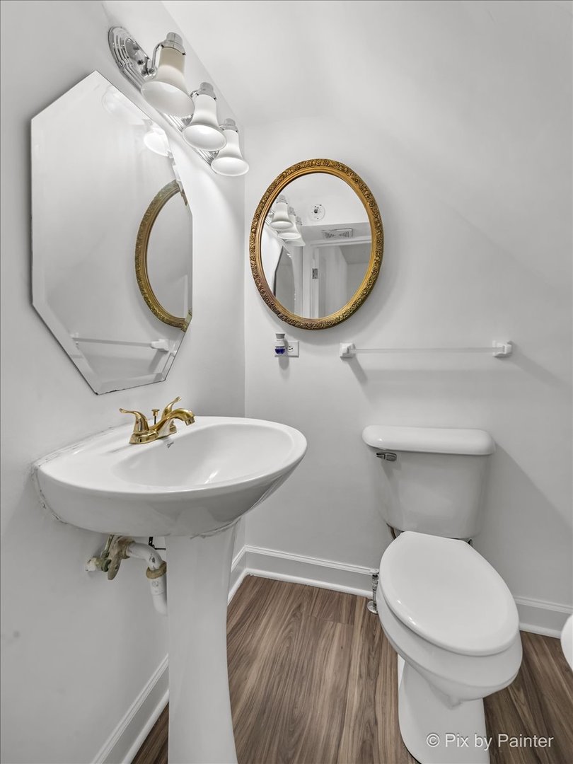 309 Griswold Street Elgin, IL 60123 - Photo 11 of 39 a bathroom with a toilet a sink and a mirror