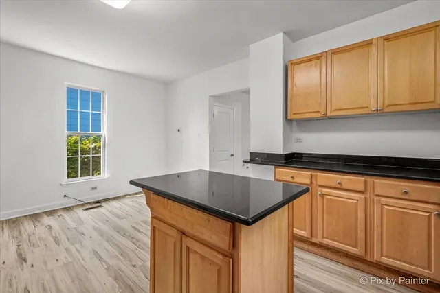 a kitchen with stainless steel appliances granite countertop a sink a stove a microwave and cabinets