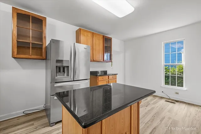 a kitchen with stainless steel appliances granite countertop a sink a microwave cabinets and a window