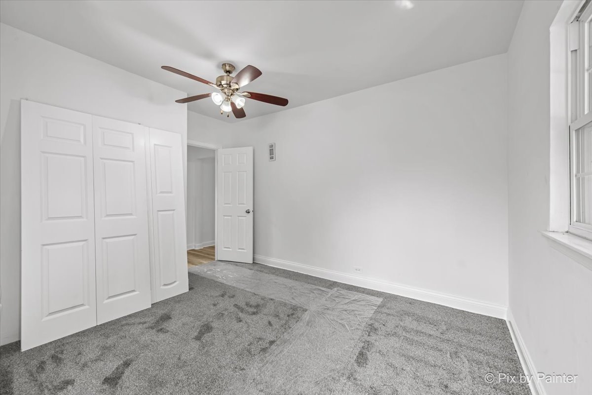 309 Griswold Street Elgin, IL 60123 - Photo 17 of 39 an empty room with windows and fan