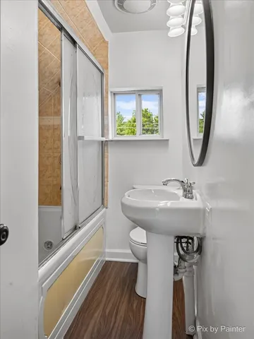 a bathroom with a sink a mirror and a shower