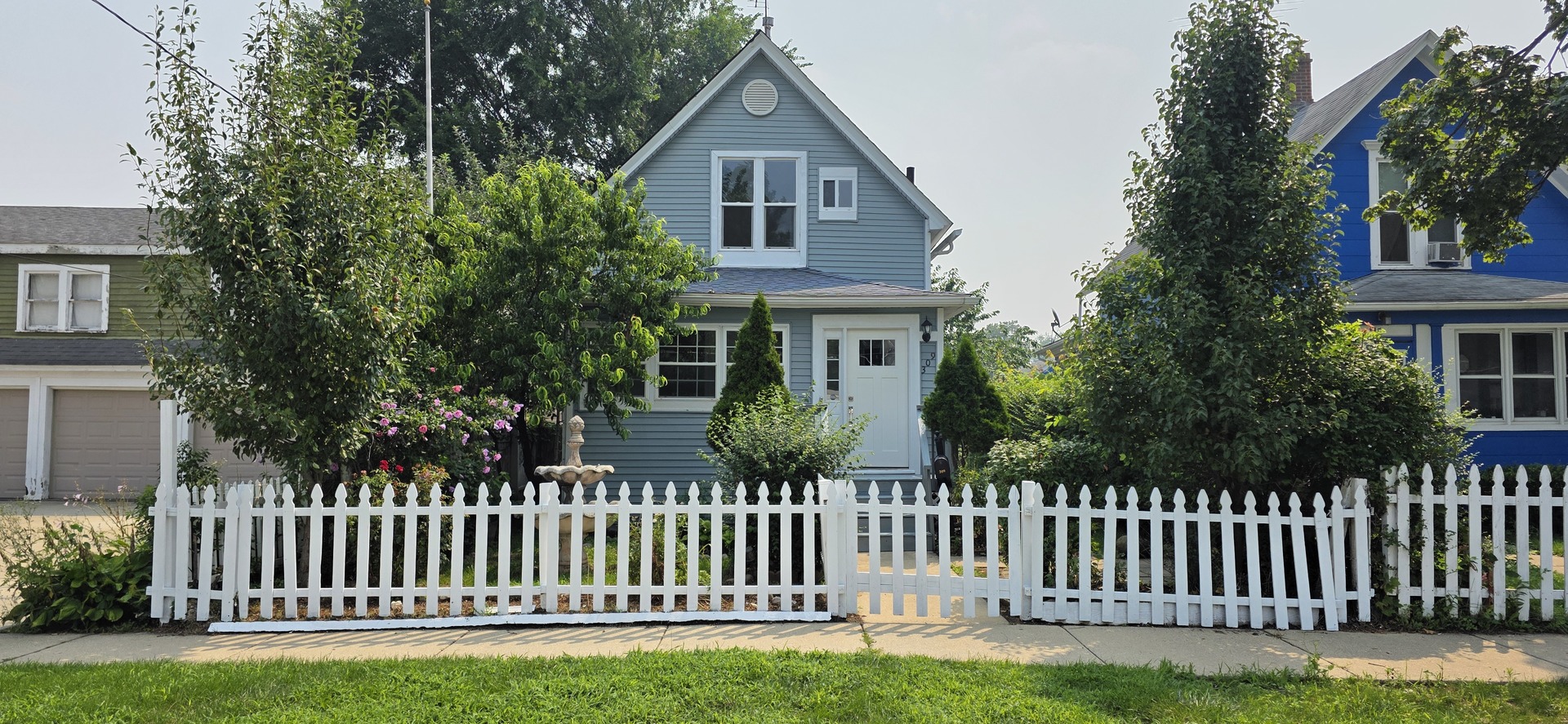 309 Griswold Street Elgin, IL 60123 - Photo 2 of 39 a front view of a house with a garden