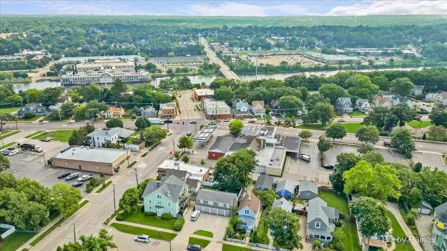 an aerial view of residential houses with outdoor space and trees