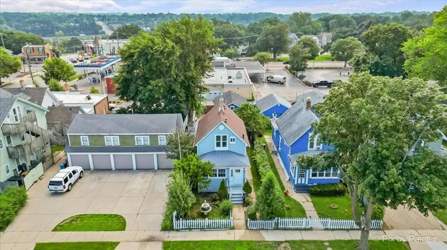 an aerial view of residential houses with outdoor space and parking