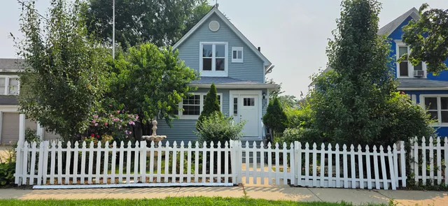 a front view of house with a garden
