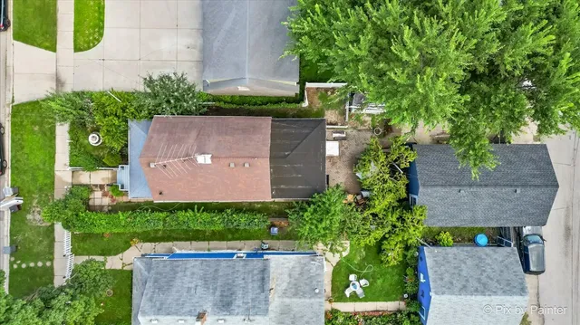 an aerial view of a house with a yard